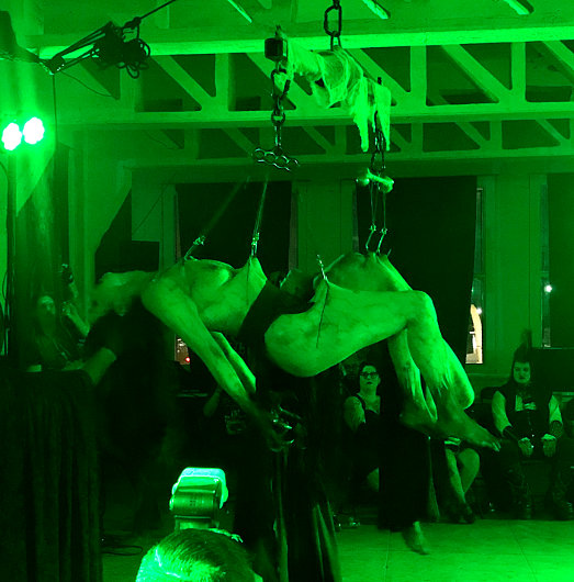 Coven of Ashes performers hanging on body suspensions provided by Embrace Chaos