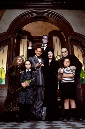 From left to right: Judith Malina as Grandma;    Christina Ricci as Wednesday Addams; Raúl Juliá as Gomez Addams; Carel Struycken as Lurch; Anjelica Huston as Morticia Addams; Christopher Lloyd as Uncle Fester; Jimmy Workman as Pugsley Addams (© Paramount Pictures)