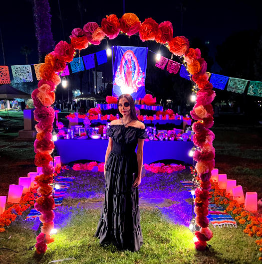 Vamp Jenn standing at a Day of the Dead altar