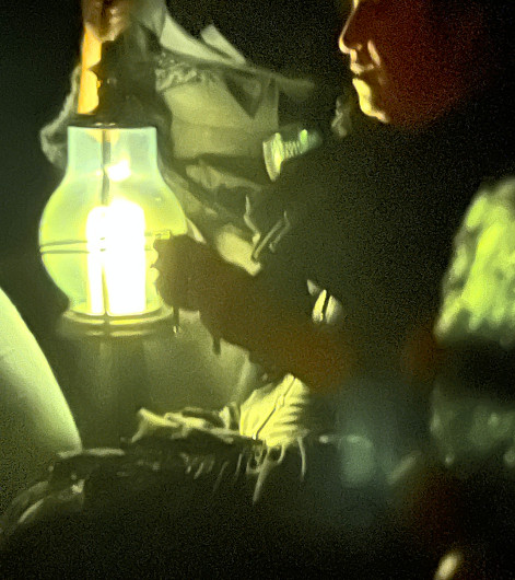 Madam Vogel using dowsing rods in the basement